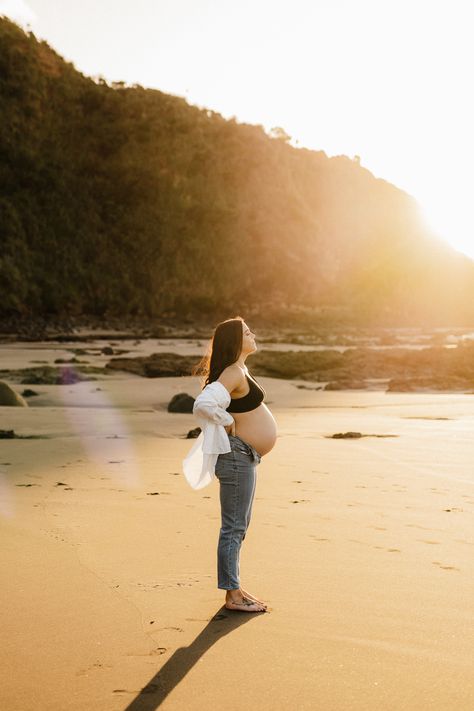 A gorgeous golden hour back lit image from a recent Sunset Maternity session in Raglan New Zealand. - Photographed by Hamilton New Zealand Maternity and Newborn Photographer Catherine Smith Photography Maternity Beach Photoshoot Jeans, Jeans And Shirt Maternity Shoot, Maternity Photo Jeans And Shirt, Jeans Beach Maternity Shoot, Beach Sunset Maternity Photoshoot, Coast Maternity Photos, Maternity Photography In Jeans, Maternity Sunset Pictures, Maternity Photography Sunset