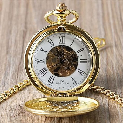 Beautifully crafted Brelsen pocket watch with a gold exterior, showcasing the intricate mechanical gears beneath a classic white face adorned with Roman numerals. Groomsmen Pocket Watch, Suit Styles, Skeleton Face, Mechanical Pocket Watch, Mechanical Hand, Unique Faces, Pocket Watches, Mechanical Movement, Gold Colour