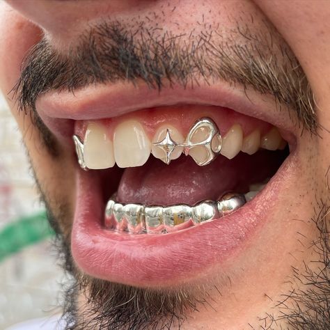 London and NYC book through my website! We’re international now :) Creative freedom custom shape, windows and 2x4 teeth on bottom in silver #grillz #grillznyc #londongrillz #silver #star Grillz Teeth Design, 2 Teeth Grillz, Window Grillz Teeth, Silver Grillz Aesthetic, Silver Grillz For Females, Unique Grillz, Grillz Teeth Men, Female Grillz Silver, Grillz Silver