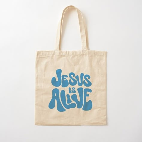 Jesus is Alive Design by Praise and Glory Shop • Millions of unique designs by independent artists. Find your thing. Christian Bag Ideas, Totes Ideas, Purple Tote, Purple Tote Bag, Christian Tote Bags, Bible Bag, Jesus Is Alive, Graphic Shirt Design, Christian Hoodies