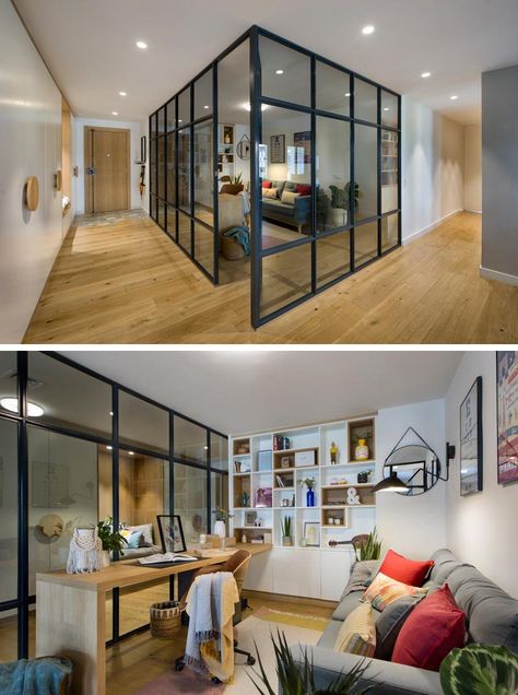 Inside this modern glass-enclosed home office is a long wood desk that meets a custom-designed bookshelf, with some of the shelves lined with wood. Opposite the desk is a comfortable grey couch, a few plants, and colorful pillows, while a rug adds a soft touch underfoot. #HomeOffice #GlassWalls #Shelving Glass Office Home, Home Office Separator Ideas, Glass Enclosed Home Office, Long Wood Desk, Enclosed Office, Glass Home Office, Office Cabin Design, Glass Wall Office, India House