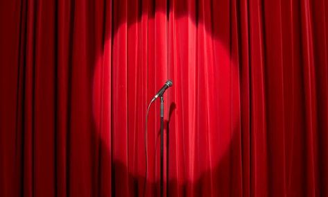 Microphone in spots light on empty stage with red curtain behind Success At Work, Standup Comedy, Theatre Curtains, Stage Curtains, Drop Cloth Curtains, About Success, Women In Leadership, Cool Curtains, Red Curtains