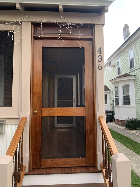 From W. Perry St. Wood Storm Door, Front Screen Door Ideas, Cabin Entryway, Screen Door Ideas, Painted Screen Doors, Wood Storm Doors, Wooden Screen Door, Diy Screen Door, Log Cabin Ideas