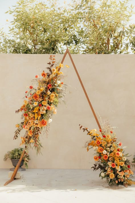 triangle wedding arch decorated in fall flowers Rusty Orange Wedding, Ranunculus Garden, Butterfly Ranunculus, Fall Wedding Arches, Ceremony Florals, Fall Palette, Floral Installations, Wedding Arch Flowers, Arch Flowers