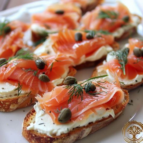 🐟 Elevate your appetizers with our Smoked Salmon Crostini! Perfect for any gathering! #GourmetBites Smoked Salmon Crostini Ingredients: Baguette, sliced (1) Cream cheese (8 oz) Smoked salmon (200g) Capers (2 tbsp) Dill, chopped (1 tbsp) Lemon juice (1 tbsp) Instructions: Toast baguette slices. Spread cream cheese on each slice. Top with smoked salmon, capers, and dill. Drizzle with lemon juice. 🍋🐟 A classy, tasty starter that's sure to impress at your next party! #SalmonCrostini Smoked Salmon Amuse Bouche, Lemon Smoked Salmon, Smoked Salmon Cheese Board, Smoked Salmon Crostini Appetizers, Salmon Starters Christmas, Salmon Aesthetic Food, Smoked Salmon Appetizer Finger Foods, Smoked Salmon Appetizers, Smoked Salmon Crostini