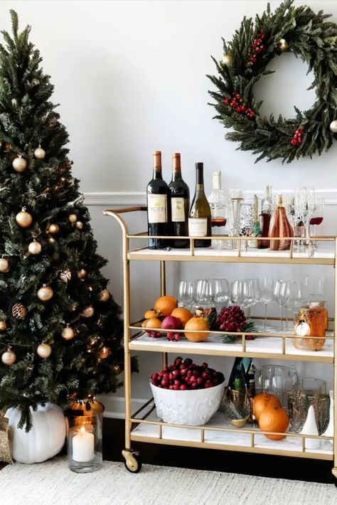 Style your bar cart for festive entertaining with a touch of sophistication. Discover tips for arranging drinks, glassware, and decorations for a chic holiday beverage station. Christmas Beverage Station, Christmas Party Bar Setup, Holiday Drink Station, Christmas Drink Bar, Christmas Bar Decor, Christmas Cocktail Bar Decor, Bar Cart Christmas, Christmas Bar Cart, Holiday Bar Cart