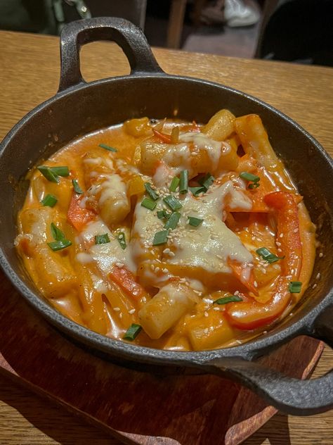 Tteokbokki is chewy rice cakes cooked in a red, spicy broth Cheesy Tteokbokki Aesthetic, Korean Teokkboki Aesthetic, Rose Tteokbokki Aesthetic, Tteokbokki Aesthetic, Buldak Carbonara, Spicy Broth, Live Deliciously, Real Aesthetic, Korean Street Food