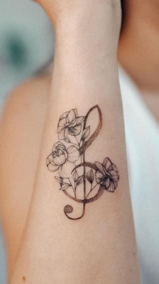 Music And Faith Tattoo, Music Tattoo Ribs, Music Symbol Tattoo Girly, Flowers With Music Notes Tattoos, G Music Note Tattoo, Wrist Music Tattoos, Peace And Music Tattoo, Music Tattoo With Flowers, Music Wrist Tattoos For Women