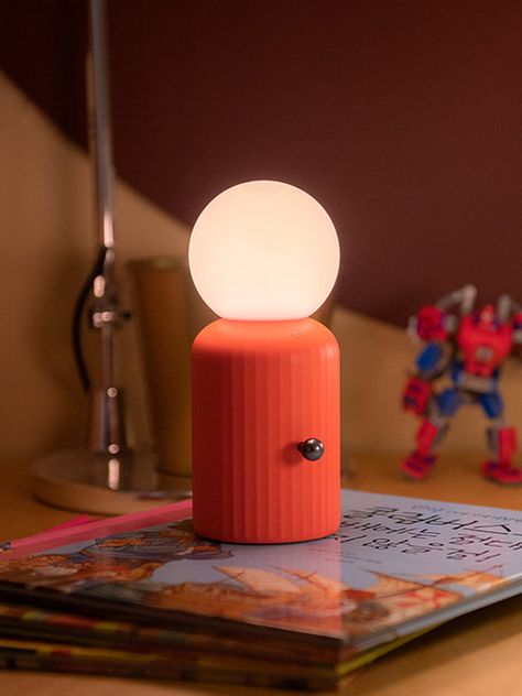 Versatile lighting! ✨ A totally unique design that takes inspiration from Lund's iconic Skittle bottle! The silicone bulb has 8 color settings and it's wireless so can easily be used anywhere. With a wireless phone charger included, this is the perfect bedside duo. Wireless. Charge the lamp with a wireless charger or color-changing bulbs with a micro USB cable. Dimmer switch to adjust brightness. Silicone nonslip base. Wireless phone charger included. Up to 14 hours of battery life from a single Cool Unique Lamps, Counter Lamp Kitchen, Small Bedside Lamp, Mid Century Modern Table Lamp, Blender Inspiration, Wireless Lamp, Fun Lamp, Eclectic Lamps, Funky Lamps