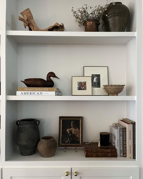 Shelf styling ideas Shelfie Follow my shop @katewinfordhome on the @shop.LTK app to shop this post and get my exclusive app-only content! #liketkit #LTKSeasonal #LTKstyletip #LTKhome @shop.ltk https://liketk.it/4LObg #shelfie #shelfstyling #interiordesign How To Style Long Floating Shelf, Shelf Decor Neutral, Minimalist Office Shelf Decor, Shelf Staging Bookcase Styling, Picture Layering On Shelf, Shelving Decor Kitchen, Living Room Shelves Styling, Thrifted Shelf Styling, Mcgee Shelf Styling