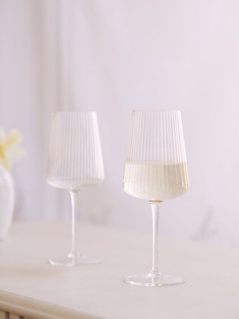 Give your dinner party the glassware it deserves with this stunning Alexis Wine Glass. Crafted out of the optic glass with intricate line detailing, this gorgeous goblet is sure to be the star of any entertaining occasion. Material: Glass Size: 8.5"H | 12oz Care: Dishwasher safe Anthropologie Wine Glasses, Textured Wine Glasses, Trendy Wine Glasses, Ribbed Wine Glasses, Pretty Wine Glasses, Aesthetic Drinking Glasses, Nordic Glassware, Drinking Glass Design, Wine Glass Aesthetic