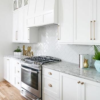 White Kitchen Cabinets with Champagne Gold Hardware Shaddock Homes, White Herringbone Backsplash, Backsplash Herringbone, Kitchen Pantries, Sofa Ottoman, Housing Ideas, White Shaker Cabinets, Farmhouse Kitchen Cabinets, Kitchen Cabinets Decor