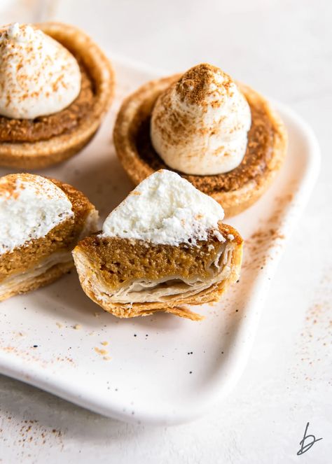 mini pumpkin pie with whipped cream cut in half to show filling and flaky crust. Pumpkin Tartlets, Mini Pumpkin Pies Recipe, Pie With Whipped Cream, Unique Pies, Thanksgiving Snacks, Individual Pies, Mini Pumpkin Pies, Mini Apple Pies, Pumpkin Pies