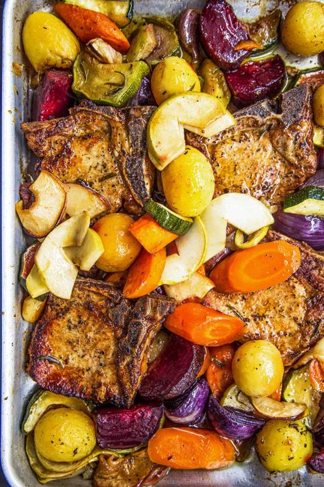 If you’re looking for the perfect autumn-themed dinner, this easy recipe for Baked Pork Chops with Apples and Vegetables is it! Thick-cut pork chops are seared and cooked in apple juice, with a colorful collection of apples, garlic, and winter veggies. Baked Pork Chops With Apples, Center Cut Pork Chop Recipes, Apple Pork Chop Recipes, Pork Chops Baked, Sheet Meals, Oven Baked Vegetables, Pork Loin Chops Recipes, Baked Boneless Pork Chops, Balsamic Pork Chops