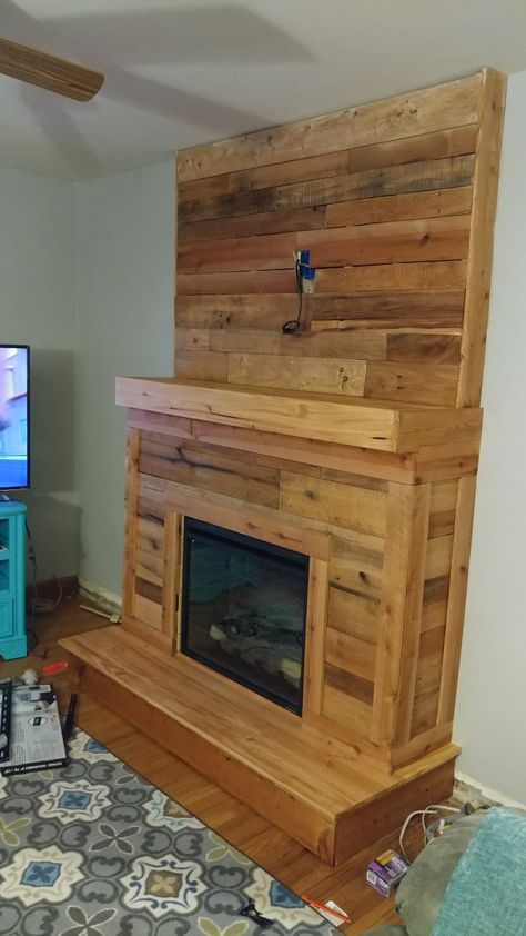 Made out of 2x4s and pallet wood. Minis the gireplace insert this cost me under 100 bucks. Pallet Wall Fireplace, Diy Pallet Fireplace, Pallet Fireplace Mantle, Pallet Fireplace Diy, Pallet Wall With Fireplace And Tv, Pallet Mantle, Barn Wood Accent Fireplace, Electric Fireplace Pallet Wall, Faux Foyer