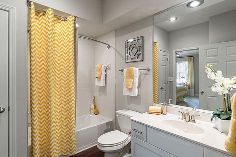 Curtain with chevron stripes brings yellow to the modern gray bathroom [Photo Credit: Valerie Ryan Photography / RealPage, Inc] Yellow Grey Bathroom, Yellow Bathroom Decor, Gray Shower Curtains, Gray Bathroom Decor, Yellow Bathroom, Gray Bathroom, Grey Bathroom, Yellow Decor, Yellow Bathrooms