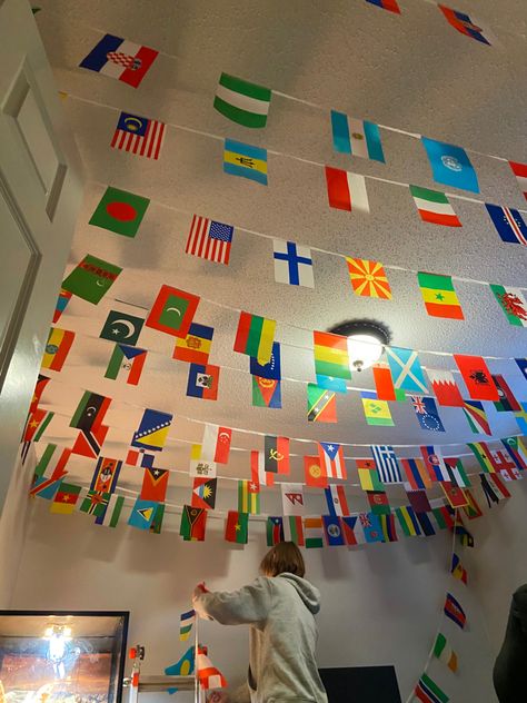 Classroom Flags Ideas, Countries Theme Party, World Flags Aesthetic, Flags Hanging From Ceiling, Flags Of The World Aesthetic, United Nations Decoration Ideas, Geography Project Ideas High School, Flags For Room Decor Aesthetic, Olympic Decorations Classroom