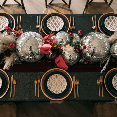 Sequin Tablecloth Wedding Tablespace with a Disco Ball Custom Centerpiece, Gold Cutlery, Gold Charger Plates, and Cross Back Chairs. Disco Themed Table Decor, Disco Ball Centrepiece, Disco Party Table Setting, Disco Centerpieces Wedding, Disco Balls Wedding Decor, Cross Back Chairs Wedding, Ball Table Decorations, Disco Ball Table Decor, Disco Tablescape