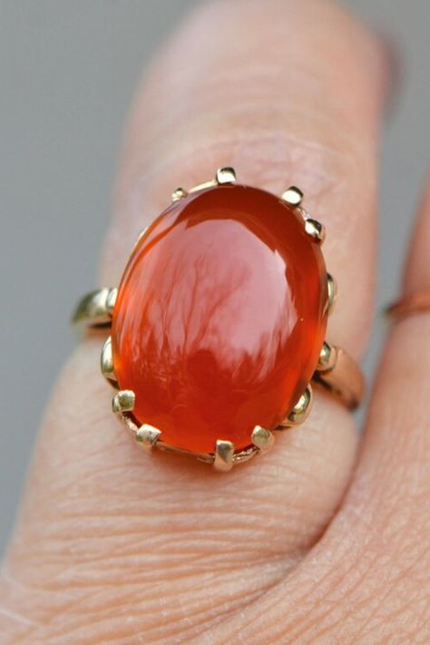 This vintage yet timeless gold ring features an eye-catching carnelian gemstone, the perfect companion to your outfit. The 14kt yellow gold setting is unique and stylish, while the large orange gemstone creates the perfect statement piece. The ring is a great gift for your wife or girlfriend, adding a touch of sophistication to her everyday wardrobe. With its intricate detail and timeless design, this beautiful ring will always be treasured. Special Occasion Jewelry, Carnelian Ring, Sparkle Jewelry, Yellow Gold Setting, Citrine Ring, Wife Gift, Timeless Accessories, Vintage Jewels, Gift For Girlfriend