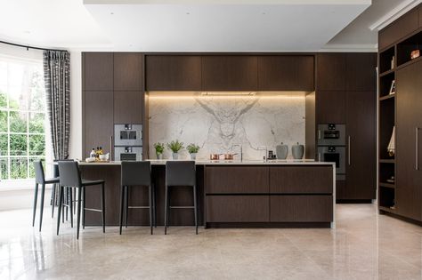 This is an example of a large contemporary kitchen in Surrey with flat-panel cabinets, dark wood cabinets, an island and white worktops. #interiordesign #design #kitchendesign #style #kitchendecor #kitchen #cabinets #cabinetdesign #kitchencupboards #kitchenorganization #kitchencabinets #darkwoodcabinets Dark Wood Kitchen Cabinets, Dark Wood Kitchens, Bespoke Kitchen Design, Kitchens Luxury, Brown Cabinets, Brown Kitchens, Wood Kitchen Cabinets, Luxury Kitchen Design, Kitchen Room Design