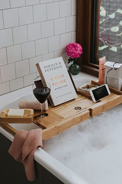 Treat your loved one to uninterrupted relaxation with the Bamboo Bathtub Caddy Tray - the perfect Mother's Day gift! This non-slip tray features compartments for a book, candles, wine glass, and more, and expands to fit all standard bathtub sizes. Hand-selected for its quality, the adjustable bath board also has a removable book holder with 3 reading angles, smartphone holder, and detachable vanity tray. Give the gift of well-deserved "me" time with the Bamboo Bathtub Caddy Tray! Bath Caddy Wooden, Bath Tray Caddy, Bathroom Tub Remodel, Bathtub Sizes, Tub Tray, Bath Board, Rustic Bath, Bathtub Caddy, Bath Table