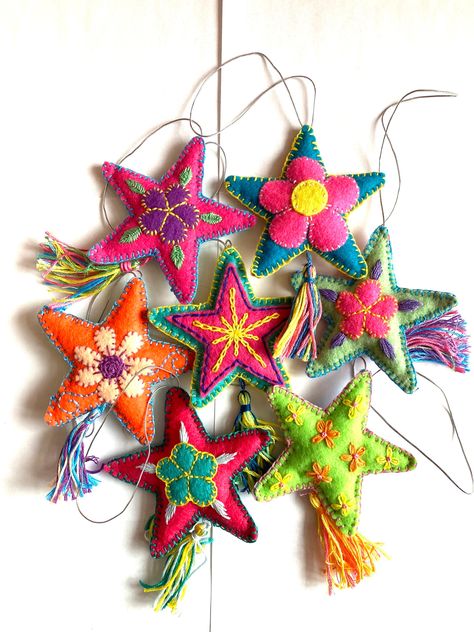 These ornaments are hand embroidered and appliquéd felt lovingly made by me here in Chicago. Brightly colored and tasseled, each ornament is unique. They are perfect for your tree, as party favors, accent notes throughout your home, or adding to a gift bag or wine bottle.  Each piece is one-of-a-kind and colors will vary. You will receive pieces chosen at random. They will be similar to those shown in photos, however colors and designs will vary since each is unique. Approximate size excluding loop and tassel is 3.25" x 3.25" x 0.5". These ornaments are embroidered on one side with a different solid felt color on the back. Mexican Folk Art Christmas, Embroidered Xmas Decorations, Anthropology Ornaments, Mexican Felt Ornaments, Stuffed Christmas Ornaments, Mexican Xmas Decorations, Seeing Gifts, Boho Ornaments Christmas, Mexican Felt Ornaments Diy