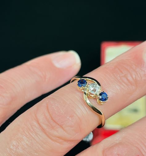 This gorgeous Sapphire and Diamond trilogy ring set on crossover shoulders, just came in and is now ready to be viewed. The central G coloured Diamond is an old Cut Diamond, and it is four claw set in 18K yellow gold, in between two round cut Sapphires of a beautiful colour. This ring is signed by Prouds circa 1920’s. Rings like these are a great anniversary gifts, and it can also be bought as a ‘push present’. DM us for enquiries 💫 _______________________________________________ #antiqu... Diamond Trilogy Ring, Push Present, Push Presents, Great Anniversary Gifts, Trilogy Ring, Ring Set, Ring Sets, Crossover, Colored Diamonds