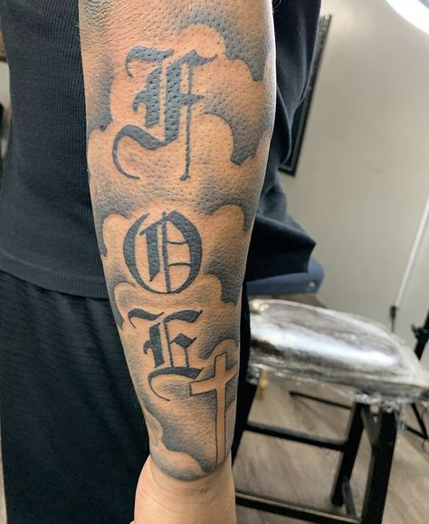 F.o.e Tattoo Men, Forearm Tattoos Lettering, Back Of The Bicep Tattoo, Cool Tattoos For Guys Sleeve, Medium Arm Tattoo Men, Foe Tattoos Men, Outter Arm Tattoo Men Sleeve, Foe Tattoos, Back Arm Tattoo For Men