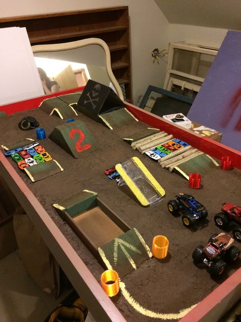 Monster Truck Train Table, Monster Truck Course Diy, Monster Truck Race Track Diy, Cardboard Monster Truck Track, Monster Truck Sand Pit Diy, Monster Truck Table Diy, Diy Monster Jam Arena, Monster Truck Activities For Kids, Diy Monster Truck Decorations