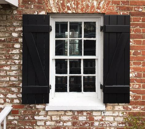 These black board and batten shutters feature a z-brace on ether side, functional hardware, and black shutter capping. #shutters #timberlaneshutters #blackshutters #boardbattenshutters Black Exterior Shutters, Craftsman Shutters, Cottage Shutters, Front Entrance Decor, Mission Style Homes, Farmhouse Shutters, Rustic Shutters, Louvered Shutters, Black Shutters