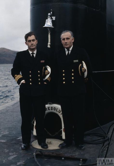 The two Commanding Officers of the Royal Navy's first Polaris submarines HMS RESOLUTION, Commander M C Henry (port crew) and Commander K D Frewer (starboard crew). They are standing on the forward casing just in front of the fin. The ship's bell can be seen affixed to the fin. Royal Navy Uniform, Navy Ranks, Royal Navy Officer, Nuclear Submarine, Navy Uniforms, Oc Inspo, Diy Sewing Clothes, Royal Navy, Sewing Clothes