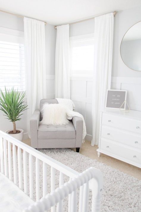 White and Grey Gender-Neutral Nursery, White and Gray Gender-Neutral Nursery with white drapes, soft gray feeding chair and gold accents Gray Gender Neutral Nursery, Nursery Chandelier, Baby Room Boy, Fresh Laundry, White Crib, Nursery Room Design, White Dining Room, Grey Nursery, White Nursery