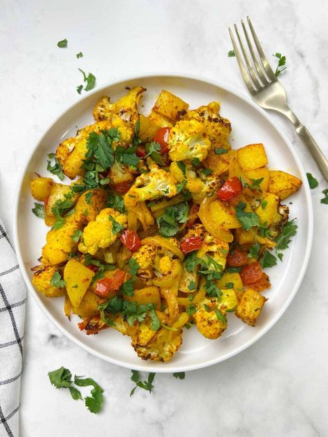 air fryer aloo gobi served on a plate garnished with cilantro and fork on the side Aloo Gobi Recipe, Gobi Recipe, Indian Cauliflower, Gobi Recipes, Indian Vegetarian Dishes, Traditional Indian Food, Cauliflower Potatoes, Aloo Gobi, Cauliflower Curry