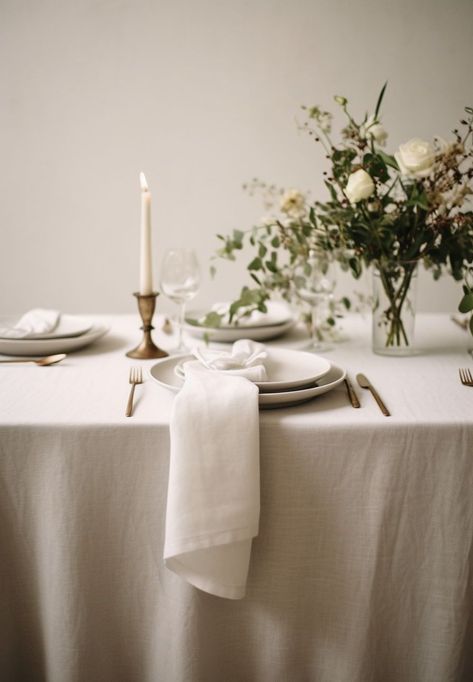 Create the perfect ambiance for an elegant wedding with a beautifully set table featuring a linen tablecloth. The soft and luxurious texture of the linen adds a touch of sophistication to the overall decor. Pair it with delicate china, sparkling glassware, and polished silverware to create a stunning tablescape. The neutral color of the linen allows for endless possibilities when it comes to floral arrangements and centerpiece designs. Tablecloth Inspiration, Gray Tablecloth, Linen Table Settings, Farmhouse Tablecloth, Floral Table Setting, Natural Farmhouse, Elegant Backdrop, Dining Table Cloth, White Linens