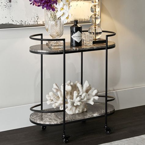 The Sundance drinks trolley is pure elegance on wheels! 😍🍸 #indoor #indoorkitchen #dining #trolley #barcart #home Black Bar Cart, Marble Shelves, Marble Shelf, Marble Bar, Serving Trolley, Bar Cart Styling, Drinks Trolley, Interiors Online, Cafe Lights