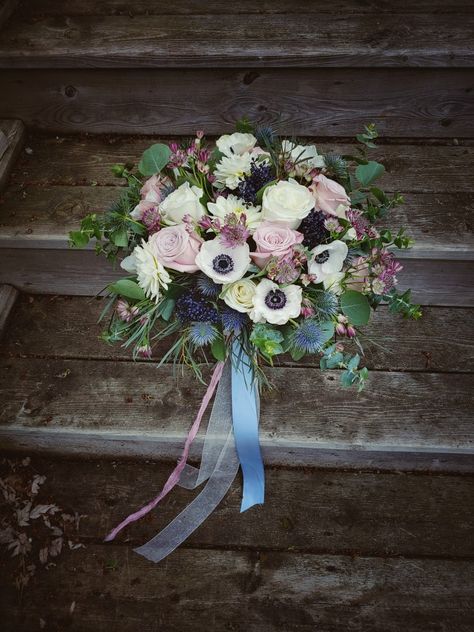 Stunning bridal bouquet with a opular blend of blue tones, dusty rose mauve, unique anemones and lush greens. Navy Blue Dusty Rose Sage Green Wedding, Dusty Blue And Mauve Wedding Theme, Mauve Blue White Wedding, Dusty Blue And Mauve Wedding Flowers, Mauve And Green Bouquet, Mauve And Dusty Blue Bouquet, Mauve And Blue Wedding, Mauve Wildflower Bouquet, Carnation Wedding Bouquet