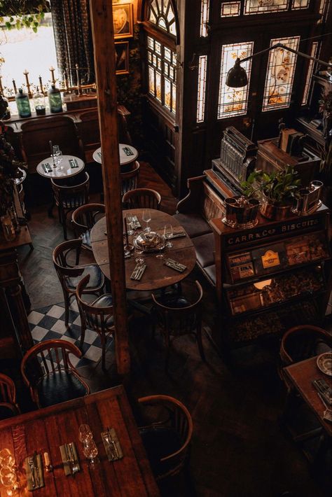 Witchy Cafe Interior, Cafe And Bar Interior, Cool Restaurant Design Interiors, Moody Bakery Interior, Gothic Coffee Shop Aesthetic, Apothecary Cafe Coffee Shop, Fantasy Cafe Coffee Shop, 1920s Coffee Shop, Mystical Coffee Shop