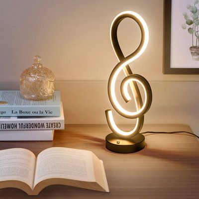 This rgb table lamp has an elegant music note aesthetic design. The black finish painted add a sense of personality. The sprial design supplies a stable and soft light also creates a comfortable atmosphere of artistic aesthetic. It is a unique table lamp for living room, bed room, office or as a bedside or night lamp for your bedroom decor. Wrought Studio™ | Wrought Studio™ Jakie Metal Novelty Lamp 15.74 H x 6.1 W x 4.72 D in / whitePlastic / Metal in Black | 15.74" H X 6.1" W X 4.72" D | Wayfai Touch Lamps For Bedroom, Bed Lamp Aesthetic, Music Note Aesthetic, Music Decor Bedroom, Aesthetic Lamps Bedroom, Music Table Decorations, Music Room Aesthetic, Bedroom Decor Music, Music Bedroom Aesthetic