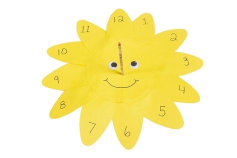 Learn how to make an easy sundial to tell time in this fun tutorial video for kids! To do this simple craft, kids will make a smiling paper sundial clock. For the sun's nose, they will use a pencil, which will act as the sundial's pointer. When they're all done, kids will take their sundial outside and place it on the ground with the 12 pointing north. The pencil will cast a shadow onto the paper sun, showing the correct time. This easy science project is ideal for children ages 5 and older with Diy Sundial, Sundial Clock, Community Cafe, Sun Clock, Easy Science Projects, Paper Sun, Sun Dial, Mum Ideas, Clock Craft