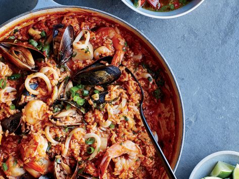 Chef Ricardo Zarate’s peruvian arroz con mariscos is like an easy seafood paella. He starts with cooked rice and flavors the fish with vibrant red chile paste and tomato salsa. Get the recipe on Food & Wine. Peruvian Seafood, Seafood And Rice, Rice Stew, Peruvian Dishes, Gross Food, Seafood Paella, Paella Recipe, Seafood Stew, Easy Seafood