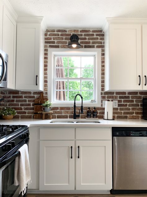 Red Brick Backsplash Kitchen White Cabinets, White Kitchen With Red Brick Backsplash, Industrial Farmhouse Backsplash, White Kitchen Cabinets Black Countertops Brick Backsplash, Red Brick Kitchen Backsplash, Decor Behind Stove, White Cabinets Brick Backsplash, Red Brick Backsplash Kitchen, White Shaker Cabinets Black Hardware