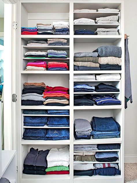 Different heights of shelves offer more flexibility in a master bedroom closet. If you don’t want to fuss with built-in shelves, try dividers that slip into larger spaces -- used here to keep track of thinner T-shirts and other items. Clothes On Shelves, Storage Ideas For Clothes, Bedroom Closet Shelves, T Shirt Storage, White Shelving Unit, Shirt Storage, Ideas For Clothes, Laundry Room Storage Shelves, Folded Clothes