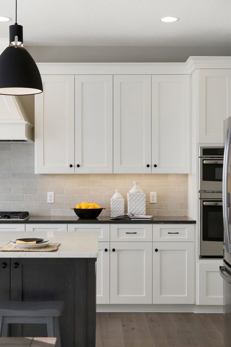 Apartment Kitchen Black Countertop, White Kitchen Cabinets Black Hardware Granite Countertops, White Kitchen With Black Hardware Modern, Cream Kitchen Black Handles, Beige Kitchen Cabinets Black Hardware, Neutral And Black Kitchen, White Black And Wood Kitchen, White Kitchen Black Counter, White Kitchen Black Hardware