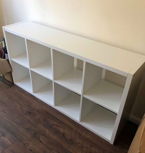 DIY fan who couldn’t afford new shelving transforms an old Ikea unit instead & it cost her next to nothing Flysta Shelf Unit Ideas, Ikea Kallax Media Wall, Ikea White Shelves, Ikea Cube Shelves, Cube Storage Decor, Ikea Cubes, White Shelving Unit, Ikea Shelving Unit, Cheap Shelves