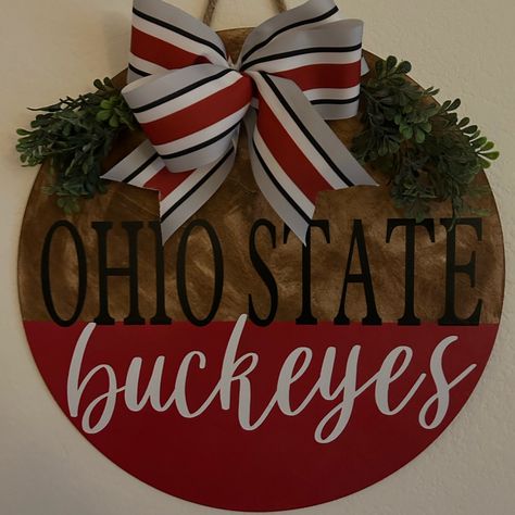 18 Inch Ohio State Buckeyes Door Hanger Stained , Painted And Protected For Outdoor Use. This Will Look Amazing On Your Door Or Will Make A Great Gift. Greenery And Bow May Vary And Back Is Not Finished. Ohio State Buckeye Wreath, Ohio State Buckeyes Door Hanger, Husker Door Hanger, Ohio State Wooden Signs, 49ers Door Hanger, Diy Football Door Hangers, Sports Door Signs, Ohio State Buckeyes Christmas, College Door Hangers