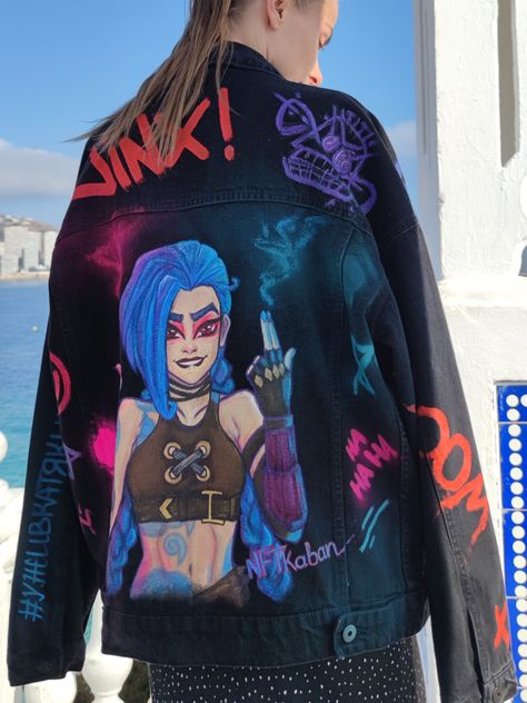 Discover the allure of Hand-Painted Black Denim Jacket! Each piece is a unique masterpiece, meticulously hand-painted by a talented artist. Embrace the customization, as no two jackets are alike. Express your individuality with wearable art that reflects your distinct personality. Stand out in style! #HandPaintedJacket #CustomizedFashion #WearableArt #ExpressYourStyle Custom Denim Jacket Ideas, Arcane Clothing, Painting Denim Jacket, Paint Clothes, Arcane Jinx, Painted Clothes Diy, Sleeveless Blazer, Painted Jeans, Clothes Diy