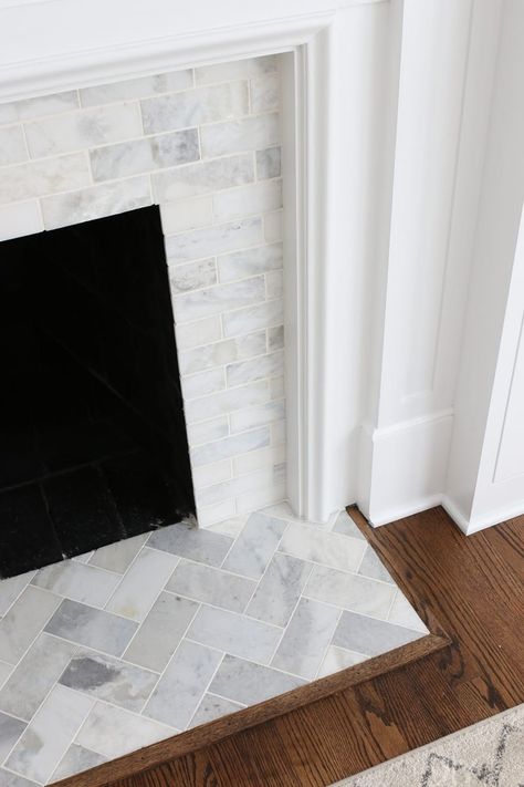 A White Marble Tile Fireplace Update | The DIY Playbook White Marble Tile Fireplace, Marble Tile Fireplace, Chevron Fireplace, Tile Hearth, Fireplace Hearth Tiles, Hearth Tiles, Charleston House, Fireplace Redo, Diy Fireplace Makeover