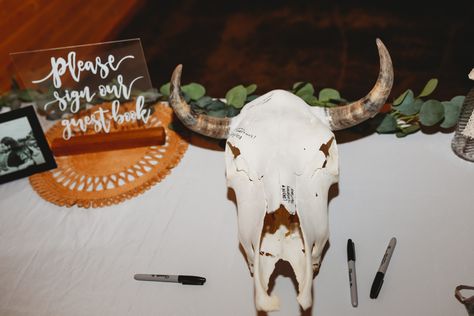 Add something different and have guest sign a cow skull for your guest book so you can hang it on your wall! Cow Skull Wedding Arch, Deer Skull Wedding Decor, Cow Skull Guest Book, Cow Skull Signing Wedding, Bull Skull Wedding Sign In, Cow Skull Wedding Guest Book, Skull Guest Book Wedding Ideas, Deer Head Guest Book, Deer Skull Wedding Guest Book