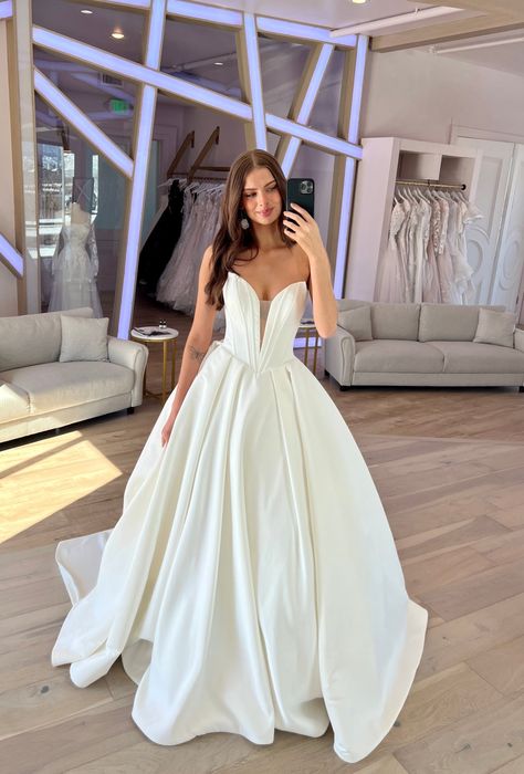 Derrick by Maggie Sottero is drama! With a plunging v-neckline and exposed boning, this bold beauty is sure to make a lasting impression! #weddingdress #deepvneckline #ballgown Maggie Sottero Ballgown, Maggie Sottero Derrick, V Cut Wedding Dress, Beautiful Ballgown, Plunging Neckline Wedding Dress, Wedding Ballgown, 2026 Wedding, Maggie Sottero Bridal, Short Engagement