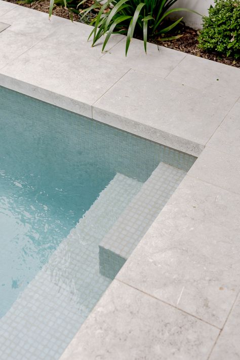 Pools With Stone Walls, Paving Around Pool Ideas, Pool Area Flooring, Concrete Pool Pavers, Outdoor Pool Tiles, Pool Limestone Pavers, Pool Edge Tile, Tiled Pool Area, Tiled Pool Steps